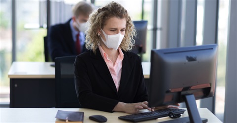 Woman using a desktop computer in office